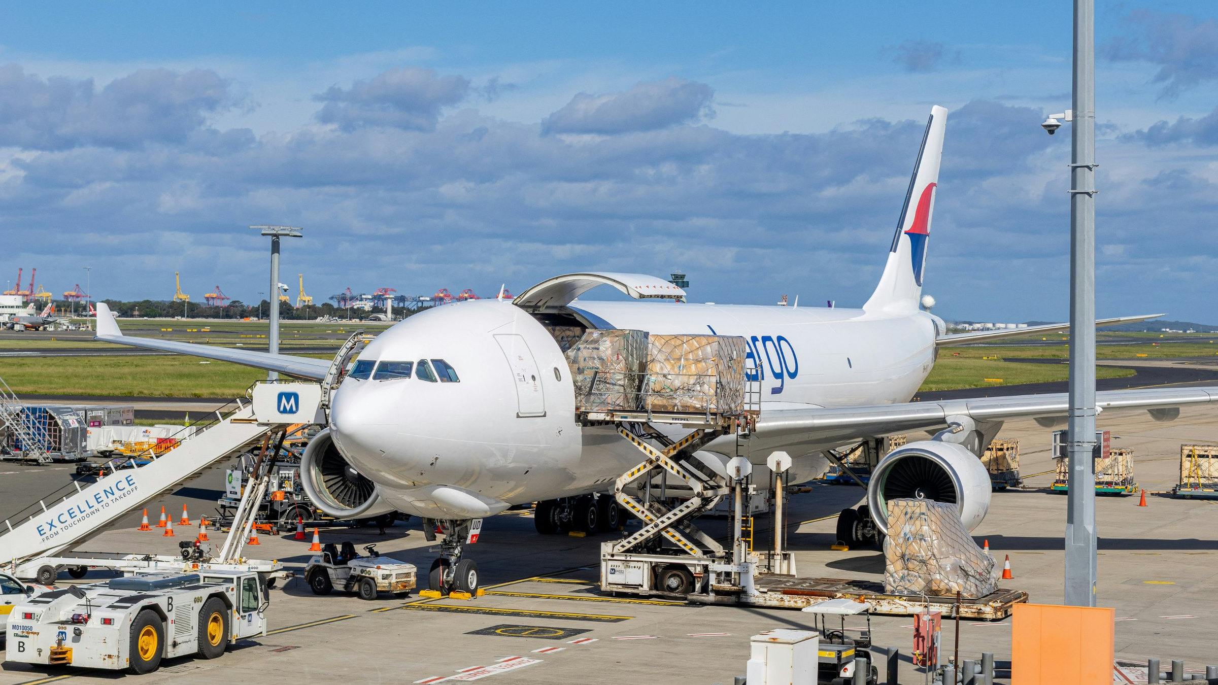 Cargo aircraft being loaded with palletised freight on the airport apron