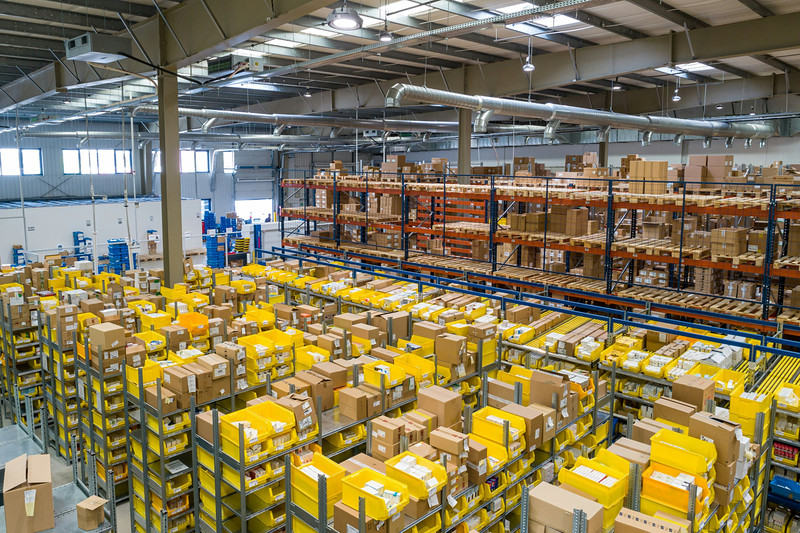 Warehouse floor with yellow picking bins and parcels