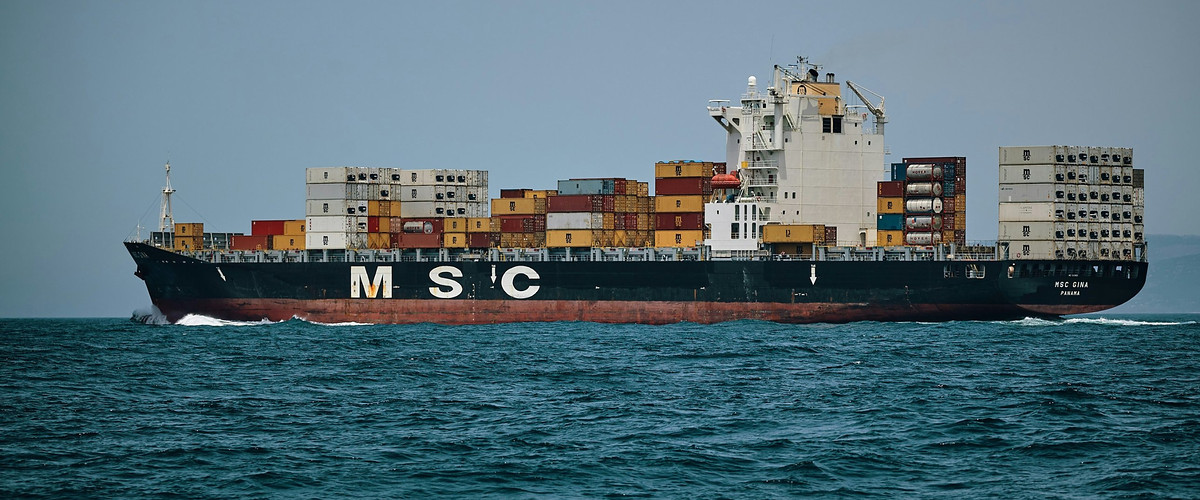 Container ship at sea carrying stacked containers
